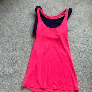 Lululemon tank, bright orangish pink with attached navy bra. No size dot.